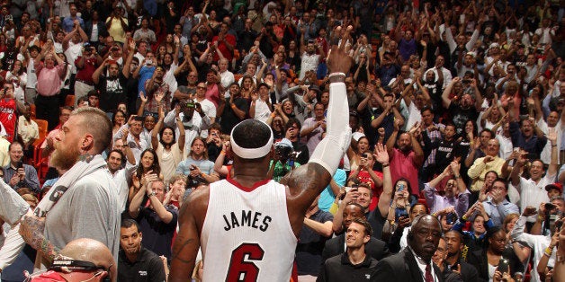 MIAMI, FL - March 3: LeBron James #6 of the Miami Heat greets the crowd after setting a career high and franchise setting record with 61 points in a game against the Charlotte Bobcats at the American Airlines Arena in Miami, Florida on Mar. 3, 2014. NOTE TO USER: User expressly acknowledges and agrees that, by downloading and/or using this photograph, user is consenting to the terms and conditions of the Getty Images License Agreement. Mandatory copyright notice: Copyright NBAE 2014 (Photo by Issac Baldizon/NBAE via Getty Images)