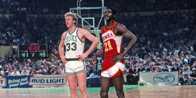BOSTON - 1983: Dominique Wilkins #21 of the Atlanta Hawks and Larry Bird #33 of the Boston Celtics stand on the court during