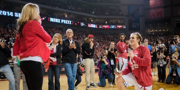 LINCOLN, NE - MARCH 9: Mike Peltz #12 of the Nebraska Cornhuskers proposes to his girl friend following senior day ceremonies prior their game against the Wisconsin Badgers at Pinnacle Bank Arena on March 9, 2014 in Lincoln, Nebraska. (Photo by Eric Francis/Getty Images)