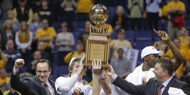 Wichita State coach Gregg Marshal, along with players Ran Baker, Fred VanVleet and Cleanthony Early, hold up the Missouri Valley Conference tournament championship trophy. Wichita State Shockers defeated the Indiana State Sycamores, 83-69, in St. Louis on Sunday, March 9, 2014. (Travis Heying/Wichita Eagle/MCT via Getty Images)