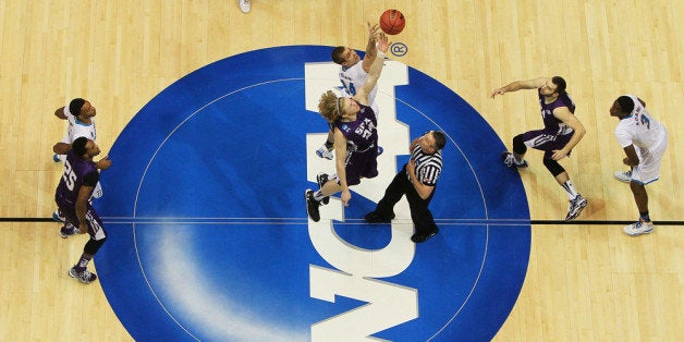 SAN DIEGO, CA - MARCH 23: Jacob Parker #34 of the Stephen F. Austin Lumberjacks tips-off against Travis Wear #24 of the UCLA Bruins to start their game during the third round of the 2014 NCAA Men's Basketball Tournament at Viejas Arena on March 23, 2014 in San Diego, California. (Photo by Jeff Gross/Getty Images)