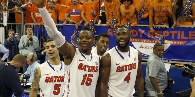 Florida's Scottie Wilbekin (5), Will Yeguete (15), and Patric Young (4) celebrate after an 84-65 victory against Kentucky at the Stephen C. O'Connell Center in Gainesville, Fla., Saturday, March 8, 2014. (Charles Bertram/Lexington Herald-Leader/MCT via Getty Images)