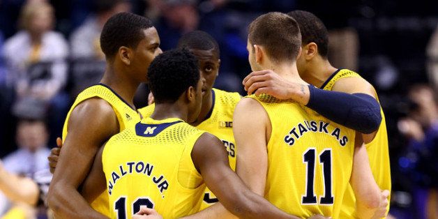 INDIANAPOLIS, IN - MARCH 16: The Michigan Wolverines huddle during the 2014 Big Ten Men's Championship against the Michigan State Spartans at Bankers Life Fieldhouse on March 16, 2014 in Indianapolis, Indiana. (Photo by Andy Lyons/Getty Images)