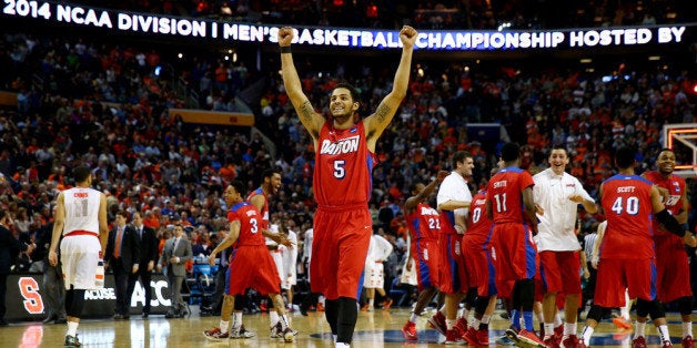 BUFFALO, NY - MARCH 22: Devin Oliver #5 of the Dayton Flyers reacts after defeating the Syracuse Orange 55-53 in the third round of the 2014 NCAA Men's Basketball Tournament at the First Niagara Center on March 22, 2014 in Buffalo, New York. (Photo by Elsa/Getty Images)