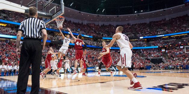 ANAHEIM, CA - MARCH 29: Nick Johnson #13 of the Arizona Wildcats lays the ball in the hoop past Frank Kaminsky #44 of the Wisconsin Badgers during the west regional final of the 2014 NCAA Men's Basketball Tournament at the Honda Center on March 29 2014 in Anaheim, California. (Photo by Paul Dye/J and L Photography/Getty Images )