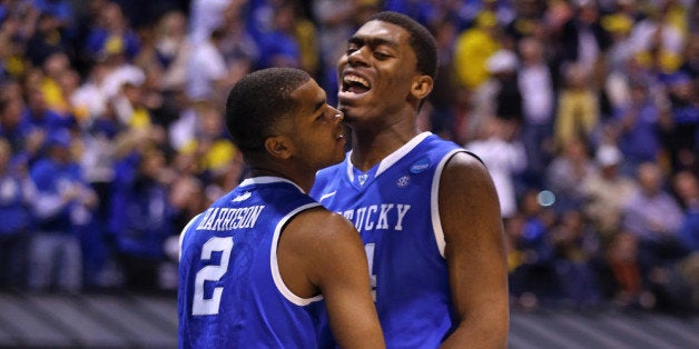 INDIANAPOLIS, IN - MARCH 30: Dakari Johnson #44 of the Kentucky Wildcats celebrates with teammate Aaron Harrison #2 after a two point play and the foul in the second half against the Michigan Wolverines during the midwest regional final of the 2014 NCAA Men's Basketball Tournament at Lucas Oil Stadium on March 30, 2014 in Indianapolis, Indiana. (Photo by Andy Lyons/Getty Images)