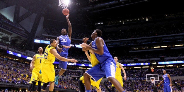INDIANAPOLIS, IN - MARCH 30: Julius Randle #30 of the Kentucky Wildcats shoots the ball over Jordan Morgan #52 of the Michig