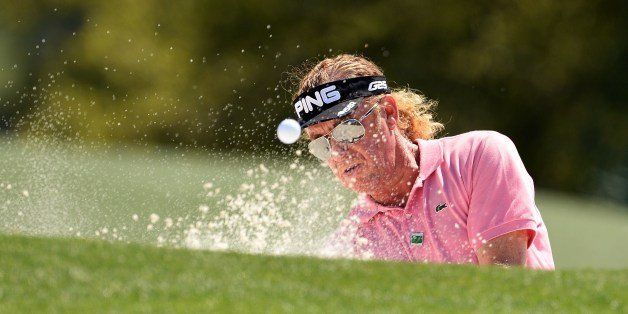 Miguel Angel Jimenez of Spain plays a shot out of a bunker during the first round of the 78th Masters Golf Tournament at Augusta National Golf Club on April 10, 2014 in Augusta, Georgia. The 78th Masters got underway early April 10, with living legends Arnold Palmer, Jack Nicklaus and Gary Player hitting the first balls as honorary starters. AFP PHOTO/Emmanuel DUNAND (Photo credit should read EMMANUEL DUNAND/AFP/Getty Images)