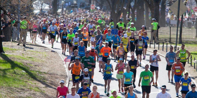 BOSTON, MA - APRIL 21: Runners head down Commonwealth Avenue toward the finish line during the 118th running of the Boston Marathon, on April 21, 2014 in Boston, Massachusetts. About one year ago, terrorists set off two bombs at the finish line. More than 36,000 runners competed this year. (Photo by Melanie Stetson Freeman/The Christian Science Monitor via Getty Images)