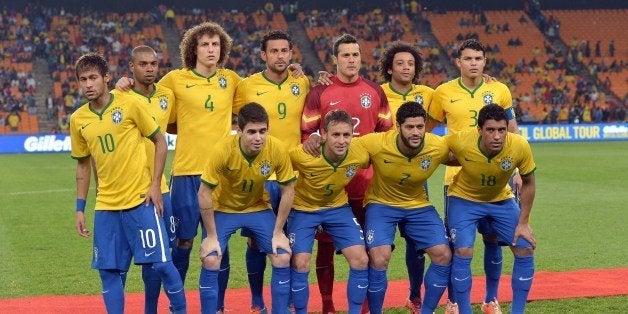 Brazil's national football team players (top L-R) forward Neymar, midfielder Fernandinho, defender David Luiz, forward Fred, goalkeeper Julio Cesar, defender Marcelo, defender Thiago Silva, (bottom L-R) midfielder Oscar, defender Rafinha, forward Hulk and midfielder Paulinho pose for a group picture before a friendly football match between South Africa and Brazil at Soccer City stadium in Soweto, outside Johannesburg, on March 5, 2014 ahead of the 2014 FIFA World Cup football tournament. Brazil won 5-0. AFP PHOTO / ALEXANDER JOE (Photo credit should read ALEXANDER JOE/AFP/Getty Images)