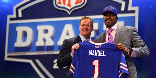 NEW YORK, NY - APRIL 25: E.J. Manuel of the Florida State Seminoles stands with NFL Commissioner Roger Goodell (L) as they hold up a jersey on stage after Manuel was picked #16 overall by the Buffalo Bills in the first round of the 2013 NFL Draft at Radio City Music Hall on April 25, 2013 in New York City. (Photo by Al Bello/Getty Images)