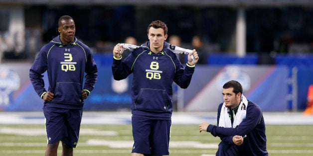 INDIANAPOLIS, IN - FEBRUARY 23: Quarterbacks (from left) Teddy Bridgewater (Louisville), Johnny Manziel (Texas A&M) and Derek Carr (Fresno State) look on as they sit out the passing drills during the 2014 NFL Combine at Lucas Oil Stadium on February 23, 2014 in Indianapolis, Indiana. (Photo by Joe Robbins/Getty Images)