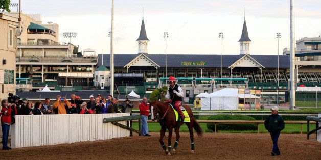 LOUISVILLE, KY - MAY 01: California Chrome walks off the track with trainer Art Sherman in front of the twin spires during early morning workouts at Churchill Downs on May 1, 2014 in Louisville, Kentucky. (Photo by Jamie Squire/Getty Images)