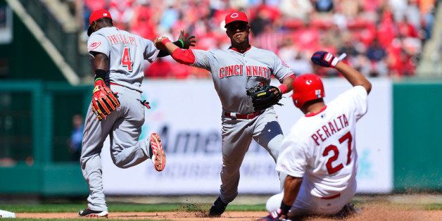 ST. LOUIS, MO - APRIL 9: Ramon Santiago #7 of the Cincinnati Reds turns a double play as Jhonny Peralta #27 of the St. Louis Cardinals slides during the eighth inning at Busch Stadium on April 9, 2014 in St. Louis, Missouri. The Reds defeated the Cardinals 4-0. (Photo by Jeff Curry/Getty Images)