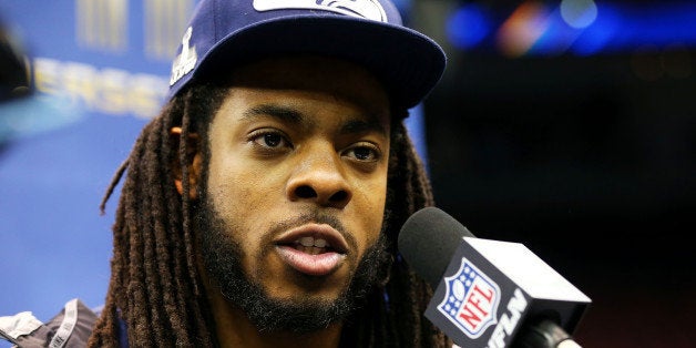 NEWARK, NJ - JANUARY 28: Cornerback Richard Sherman #25 of the Seattle Seahawks speaks to the media during Super Bowl XLVIII Media Day at the Prudential Center on January 28, 2014 in Newark, New Jersey. Super Bowl XLVIII will be played between the Seattle Seahawks and the Denver Broncos on February 2. (Photo by Elsa/Getty Images)