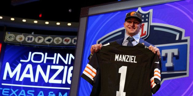 NEW YORK, NY - MAY 08: Johnny Manziel of the Texas A&M Aggies poses with a jersey after he was picked #22 overall by the Cleveland Browns during the first round of the 2014 NFL Draft at Radio City Music Hall on May 8, 2014 in New York City. (Photo by Elsa/Getty Images)