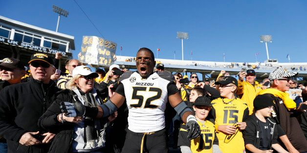 LEXINGTON, KY - NOVEMBER 9: Michael Sam #52 of the Missouri Tigers celebrates with fans after the game against the Kentucky Wildcats at Commonwealth Stadium on November 9, 2013 in Lexington, Kentucky. Missouri won 48-17. (Photo by Joe Robbins/Getty Images)