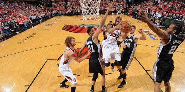 PORTLAND, OR - MAY 12: Damian Lillard #0 of the Portland Trail Blazers drives to the basket during Game Four of the Western Conference Semifinals between the Portland Trail Blazers and the San Antonio Spurs during the 2014 NBA Playoffs on May 12, 2014 at the Moda Center in Portland, Oregon. NOTE TO USER: User expressly acknowledges and agrees that, by downloading and/or using this Photograph, user is consenting to the terms and conditions of the Getty Images License Agreement. Mandatory Copyright Notice: Copyright 2013 NBAE (Photo by Garrett W. Ellwood/NBAE via Getty Images)