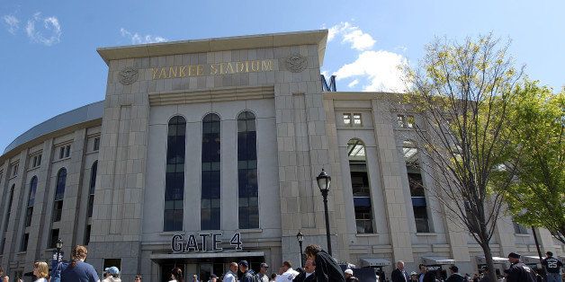 NEW YORK, NY - APRIL 13: Fans walks past the front of Yankee Stadium prior to the home opener between the New York Yankees and the Los Angeles Angels on April 13, 2012 in the Bronx borough of New York City. (Photo by Nick Laham/Getty Images)