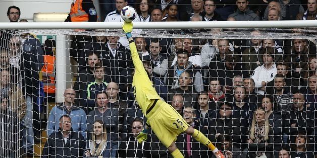 Tottenham Hotspur's French goalkeeper Hugo Lloris tips the ball over the bar to make a save during the English Premier League football match between Tottenham Hotspur and Fulham at White Hart Lane in north London on April 19, 2014. AFP PHOTO / ADRIAN DENNISRESTRICTED TO EDITORIAL USE. No use with unauthorized audio, video, data, fixture lists, club/league logos or live services. Online in-match use limited to 45 images, no video emulation. No use in betting, games or single club/league/player publications. (Photo credit should read ADRIAN DENNIS/AFP/Getty Images)