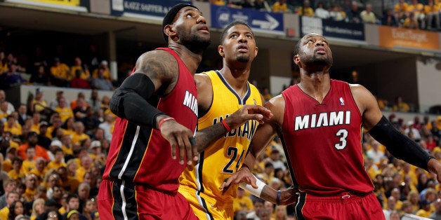 INDIANAPOLIS - MAY 18: Paul George #24 of the Indiana Pacers battles for position against LeBron James #6 and Dwyane Wade #3 of the Miami Heat in game one of the East Conference Finals at Bankers Life Fieldhouse on May 18, 2014 in Indianapolis, Indiana. NOTE TO USER: User expressly acknowledges and agrees that, by downloading and or using this Photograph, user is consenting to the terms and condition of the Getty Images License Agreement. Mandatory Copyright Notice: 2014 NBAE (Photo by Ron Hoskins/NBAE via Getty Images)