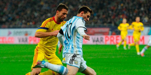BUCHAREST, ROMANIA - MARCH 05: Lionel Messi (R) of Argentina and Razvan Rat-Dinca (L) of Romania in action during a friendly match between Romania and Argentina at Arena Nationala Stadium on March 05, 2014 in Bucharest, Romania. (Photo by Tom Dulat/LatinContent/Getty Images) 