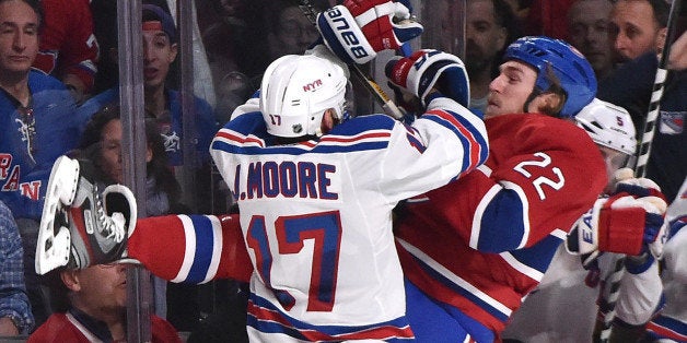 MONTREAL, QC - MAY 27: John Moore #17 of the New York Rangers checks into the boards Dale Weise #22 of the Montreal Canadiens in Game Five of the Eastern Conference Final during the 2014 NHL Stanley Cup Playoffs at the Bell Centre on May 27, 2014 in Montreal, Quebec, Canada. (Photo by Francois Lacasse/NHLI via Getty Images)