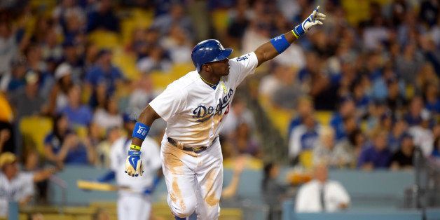 Los Angeles Dodgers right fielder Yasiel Puig gestures after hitting a three-run home during the fourth inning of a baseball game against the Miami Marlins, Monday, May 12, 2014, in Los Angeles. (AP Photo)