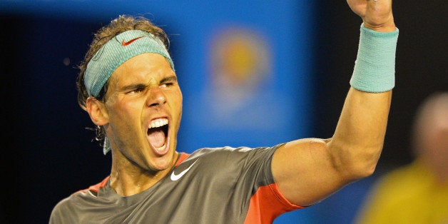 Spain's Rafael Nadal celebrates his victory against Switzerland's Roger Federer during their men's singles semi-final match on day 12 of the 2014 Australian Open tennis tournament in Melbourne on January 24, 2014. IMAGE RESTRICTED TO EDITORIAL USE - STRICTLY NO COMMERCIAL USE AFP PHOTO / SAEED KHAN (Photo credit should read SAEED KHAN/AFP/Getty Images)