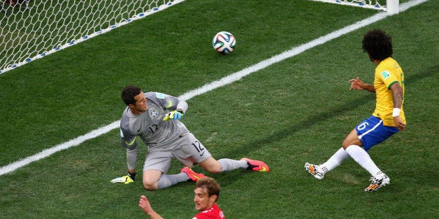 SAO PAULO, BRAZIL - JUNE 12: Julio Cesar (L) and Marcelo of Brazil watch as a deflected shot goes in during the 2014 FIFA Wor