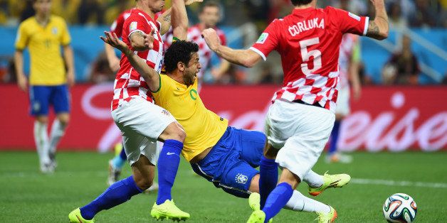 SAO PAULO, BRAZIL - JUNE 12: Fred of Brazil falls to the field in the box against Dejan Lovren of Croatia in the second half during the 2014 FIFA World Cup Brazil Group A match between Brazil and Croatia at Arena de Sao Paulo on June 12, 2014 in Sao Paulo, Brazil. (Photo by Buda Mendes/Getty Images)