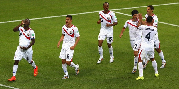 FORTALEZA, BRAZIL - JUNE 14: Joel Campbell of Costa Rica (L) celebrates scoring his team's first goal with the ball under his jersey during the 2014 FIFA World Cup Brazil Group D match between Uruguay and Costa Rica at Castelao on June 14, 2014 in Fortaleza, Brazil. (Photo by Michael Steele/Getty Images)