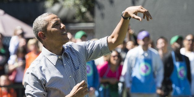 US President Barack Obama follows through after shooting a basketball during the annual White House Easter Egg Roll on the South Lawn of the White House in Washington, DC, April 21, 2014. The 126th annual White House Easter Egg Roll, the largest annual public event at the White House with more than 30,000 attendees expected, features live music, sports courts, cooking stations, storytelling and Easter egg rolling, with the theme, 'Hop into Healthy, Swing into Shape.' AFP PHOTO / Saul LOEB (Photo credit should read SAUL LOEB/AFP/Getty Images)