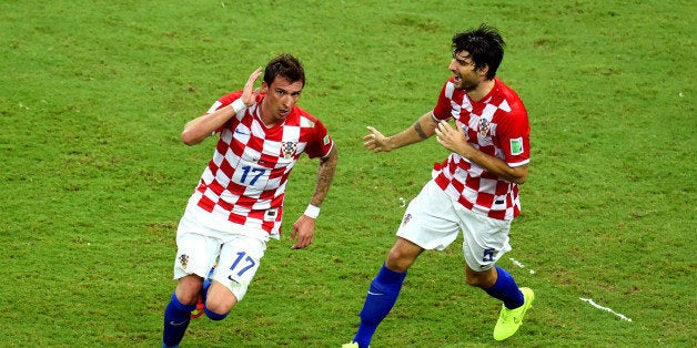 MANAUS, BRAZIL - JUNE 18: Mario Mandzukic of Croatia celebrates scoring his team's third goal during the 2014 FIFA World Cup Brazil Group A match between Cameroon and Croatia at Arena Amazonia on June 18, 2014 in Manaus, Brazil. (Photo by Stu Forster/Getty Images)