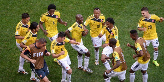 Colombia's players dance after scoring a goal during the Group C football match between Colombia and Ivory Coast at the Mane Garrincha National Stadium in Brasilia during the 2014 FIFA World Cup on June 19, 2014. AFP PHOTO / EVARISTO SA (Photo credit should read EVARISTO SA/AFP/Getty Images)