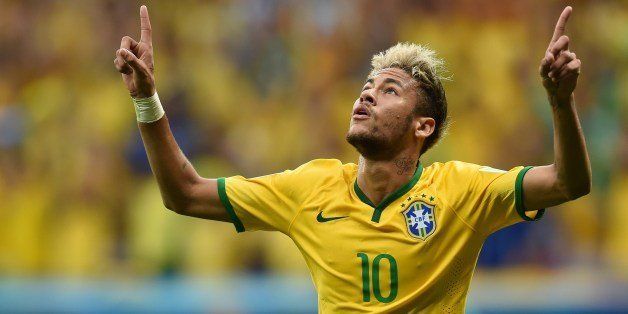 Brazil's forward Neymar celebrates after scoring a second goal during a Group A football match between Cameroon and Brazil at the Mane Garrincha National Stadium in Brasilia during the 2014 FIFA World Cup on June 23, 2014. AFP PHOTO / PEDRO UGARTE (Photo credit should read PEDRO UGARTE/AFP/Getty Images)