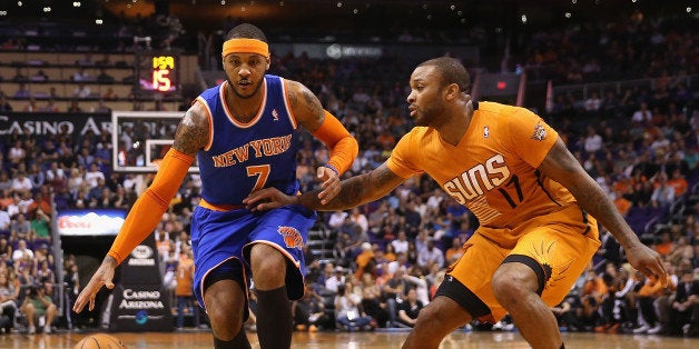 PHOENIX, AZ - MARCH 28: Carmelo Anthony #7 of the New York Knicks handles the ball under pressure from P.J. Tucker #17 of the Phoenix Suns during the first half of the NBA game at US Airways Center on March 28, 2014 in Phoenix, Arizona. NOTE TO USER: User expressly acknowledges and agrees that, by downloading and or using this photograph, User is consenting to the terms and conditions of the Getty Images License Agreement. (Photo by Christian Petersen/Getty Images)