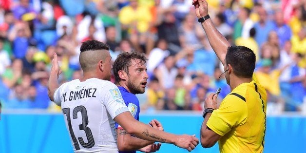 Mexican referee Marco Antonio Rodriguez Moreno (R) shows the red card to Italy's midfielder Claudio Marchisio (C) during the Group D football match between Italy and Uruguay at the Dunas Arena in Natal during the 2014 FIFA World Cup on June 24, 2014. AFP PHOTO / GIUSEPPE CACACE (Photo credit should read GIUSEPPE CACACE/AFP/Getty Images)