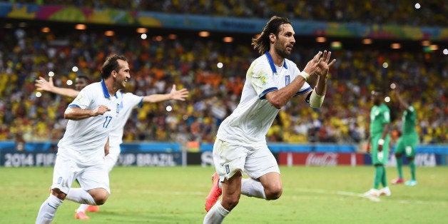 FORTALEZA, BRAZIL - JUNE 24: Giorgos Samaras of Greece celebrates scoring his team's second goal on a penalty kick during the 2014 FIFA World Cup Brazil Group C match between Greece and the Ivory Coast at Castelao on June 24, 2014 in Fortaleza, Brazil. (Photo by Laurence Griffiths/Getty Images)