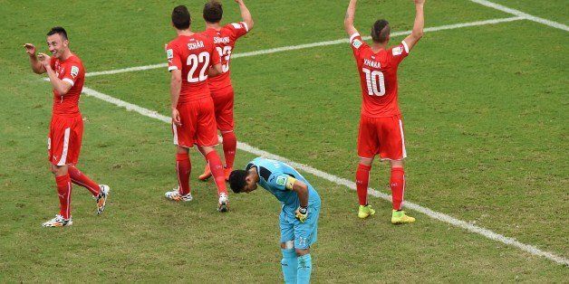 Honduras' goalkeeper Noel Valladares (front) reacts as (back L-R) Switzerland's forward Josip Drmic, defender Fabian Schaer, midfielder Xherdan Shaqiri and midfielder Granit Xhaka celebrate their third goal during the Group E football match between Honduras and Switzerland at the Amazonia Arena in Manaus during the 2014 FIFA World Cup on June 25, 2014. AFP PHOTO / LUIS ACOSTA (Photo credit should read LUIS ACOSTA/AFP/Getty Images)