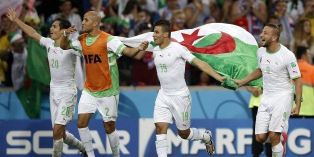 Algeria's defender Aissa Mandi, Algeria's defender Madjid Bougherra, Algeria's midfielder Saphir Taider and Algeria's forward Nabil Ghilas celebrate at the end of their Group H football match against Russia at the Baixada Arena in Curitiba during the 2014 FIFA World Cup on June 26, 2014. AFP PHOTO / ADRIAN DENNIS (Photo credit should read ADRIAN DENNIS/AFP/Getty Images)
