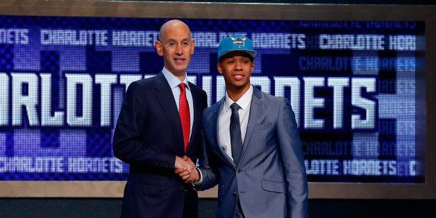 NEW YORK, NY - JUNE 26: Shabazz Napier of Connecticut (R) shakes hands with NBA Commissioner Adam Silver after being drafted with the #24 overall pick by the Charlotte Hornets during the 2014 NBA Draft at Barclays Center on June 26, 2014 in the Brooklyn borough of New York City. NOTE TO USER: User expressly acknowledges and agrees that, by downloading and/or using this Photograph, user is consenting to the terms and conditions of the Getty Images License Agreement. (Photo by Mike Stobe/Getty Images)