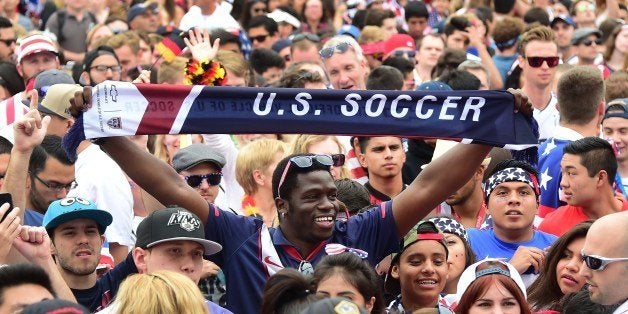 US fans show their support while gathered to watch off a big screen at Hermosa Beach, California on June 26, 2014, as Thomas Muller scored the lone goal for Germany in a 1-0 win over the United States during their final first round match at the FIFA 2014 World Cup in Brazil. The USA were helped through by Portugal's 2-1 victory over Ghana. AFP PHOTO/Frederic J. BROWN (Photo credit should read FREDERIC J. BROWN/AFP/Getty Images)