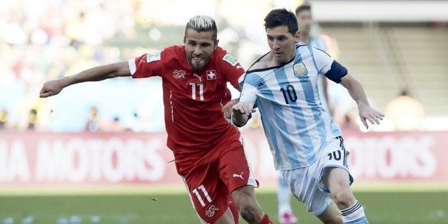 Argentina's forward and captain Lionel Messi (R) and Switzerland's midfielder Valon Behrami vie for the ball during a Round of 16 football match between Argentina and Switzerland at Corinthians Arena in Sao Paulo during the 2014 FIFA World Cup on July 1, 2014. AFP PHOTO / JUAN MABROMATA (Photo credit should read JUAN MABROMATA/AFP/Getty Images)