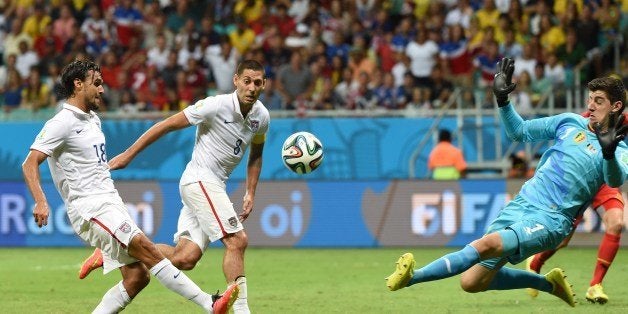 US forward Chris Wondolowski (L) shoots past Belgium's goalkeeper Thibaut Courtois during a Round of 16 football match betwee