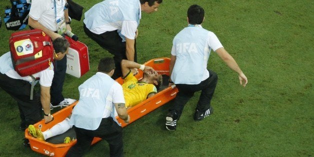 Brazil's forward Neymar is carried on a stretcher after being injured during the quarter-final football match between Brazil and Colombia at the Castelao Stadium in Fortaleza during the 2014 FIFA World Cup on July 4, 2014. AFP PHOTO / POOL / FABRIZIO BENSCH (Photo credit should read FABRIZIO BENSCH/AFP/Getty Images)