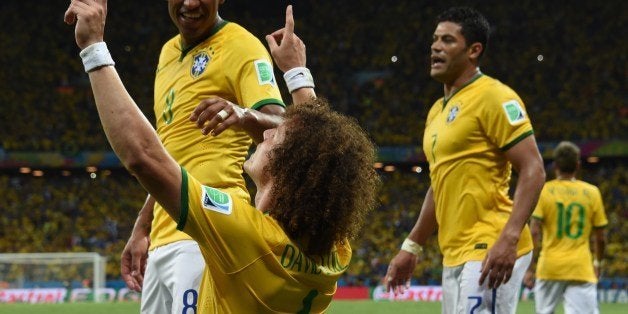 Brazil's defender David Luiz (C) celebrates scoring during the quarter-final football match between Brazil and Colombia at the Castelao Stadium in Fortaleza during the 2014 FIFA World Cup on July 4, 2014. AFP PHOTO / VANDERLEI ALMEIDA (Photo credit should read VANDERLEI ALMEIDA/AFP/Getty Images)