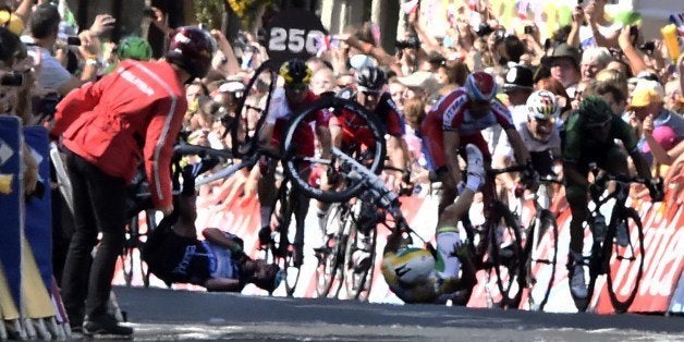 Australia's Simon Gerrans and Britain's Mark Cavendish fall near the finish line at the end of the 190.5 km first stage of the 101st edition of the Tour de France cycling race on July 5, 2014 between Leeds and Harrogate, northern England. The 2014 Tour de France gets underway on July 5 in the streets of Leeds and ends on July 27 down the Champs-Elysees in Paris. AFP PHOTO / LIONEL BONAVENTURE (Photo credit should read LIONEL BONAVENTURE/AFP/Getty Images)