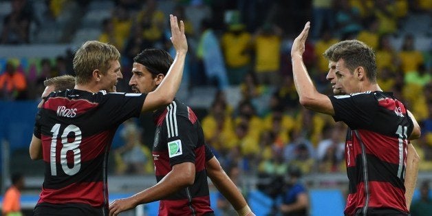 Germany's forward Miroslav Klose (R) celebrates with teammates after scoring during the semi-final football match between Brazil and Germany at The Mineirao Stadium in Belo Horizonte on July 8, 2014, during the 2014 FIFA World Cup . AFP PHOTO / PEDRO UGARTE (Photo credit should read PEDRO UGARTE/AFP/Getty Images)