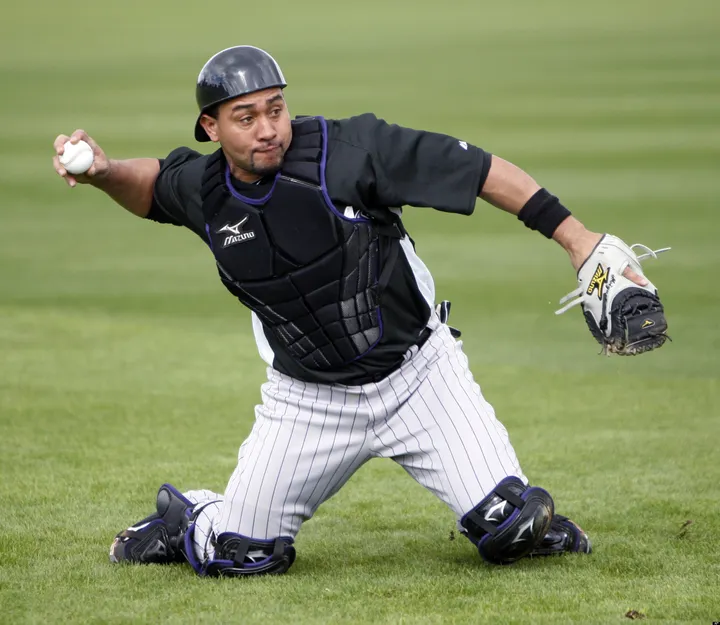 Colorado Rockies' Miguel Olivo, left, follows the flight of his